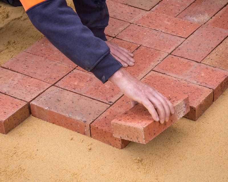laying bricks on the ground